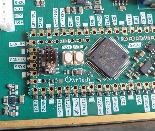 photo of SPIN microcontroller's debugger connector with tin droplet